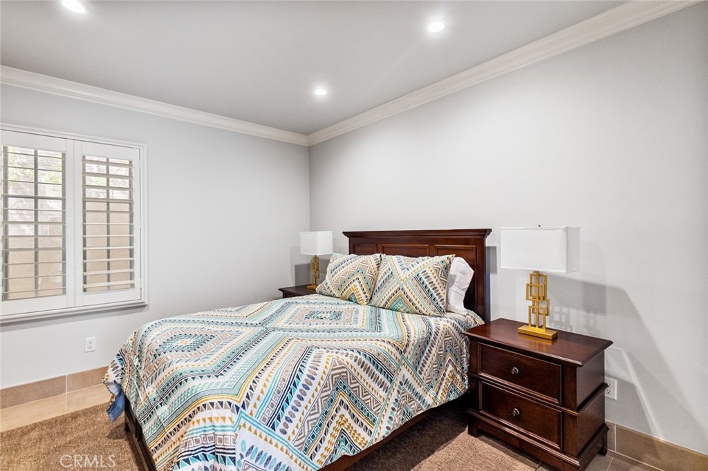 121 Treasure Irvine, CA 92602 - Photo 35 of 41 a bedroom with a bed and wooden floor