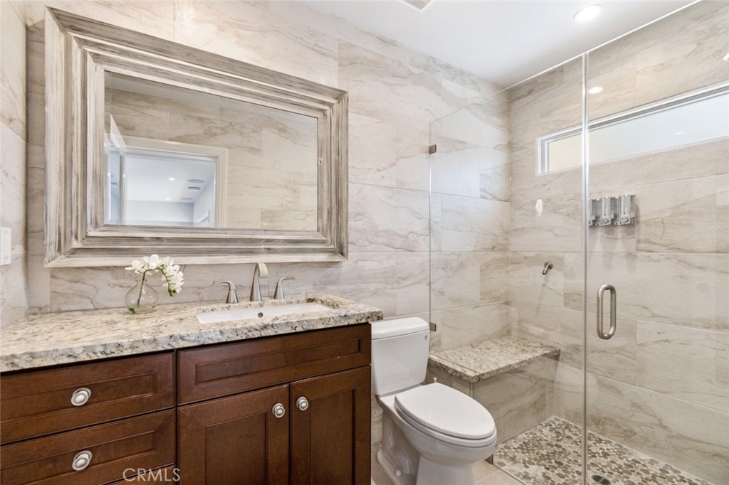 121 Treasure Irvine, CA 92602 - Photo 36 of 41 a bathroom with a granite countertop toilet sink and mirror