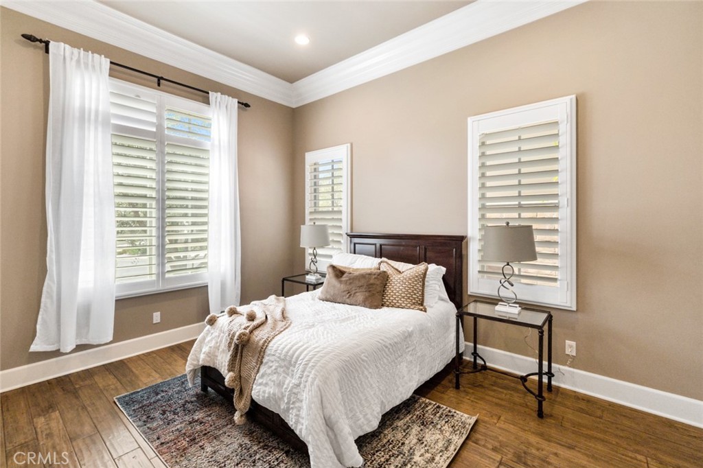121 Treasure Irvine, CA 92602 - Photo 8 of 41 a bedroom with a bed wooden floor and a window