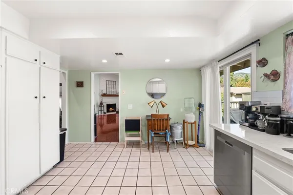 a view of a kitchen with dining area closet area and windows