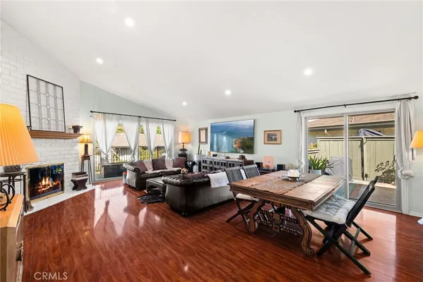 a living room with fireplace furniture and a wooden floor