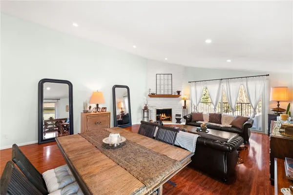 a living room with furniture fireplace and a table