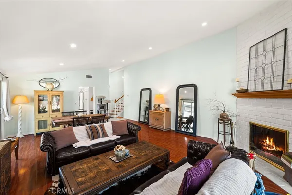 a living room with furniture fireplace and window