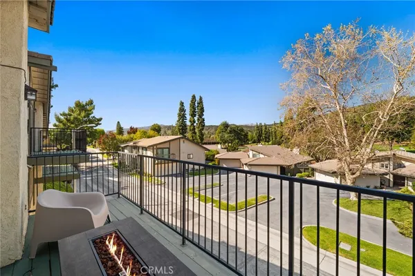 a view of a balcony with wooden floor and fence