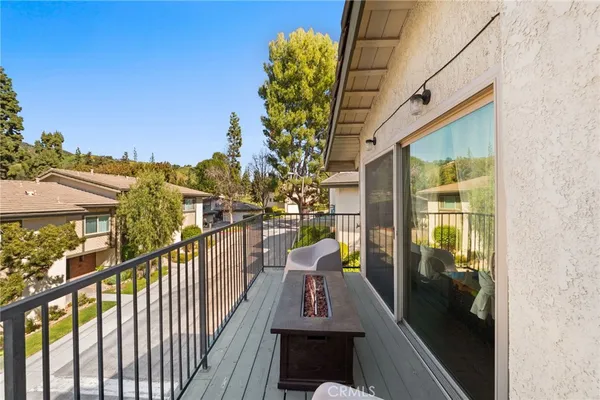 a view of a balcony with flower plants