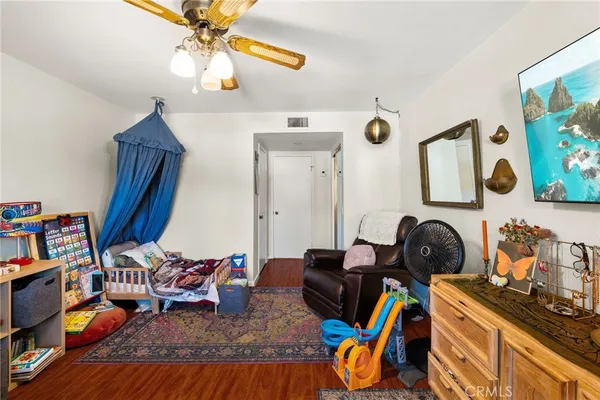 a living room with furniture a rug and gym equipment
