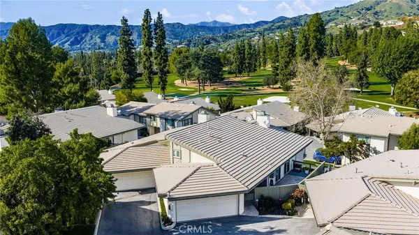 an aerial view of a house with a yard and sitting area