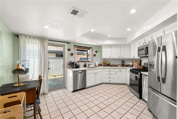 a kitchen with a sink stainless steel appliances and cabinets