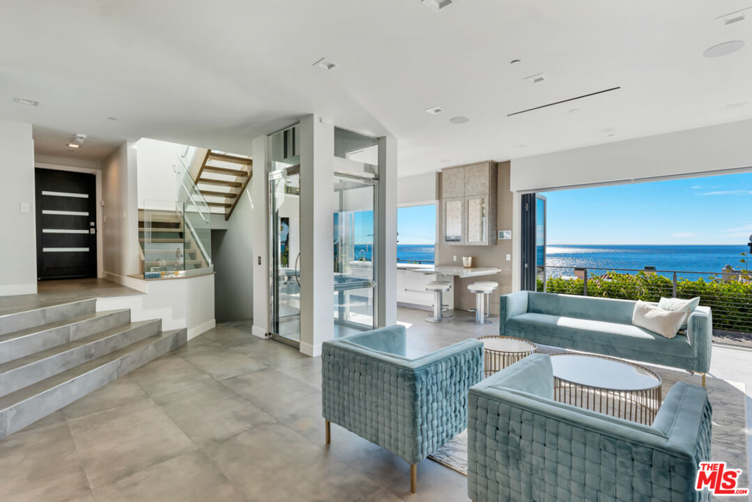 25423 Malibu Road Malibu, CA 90265 - Photo 12 of 71 a living room with furniture and a large window