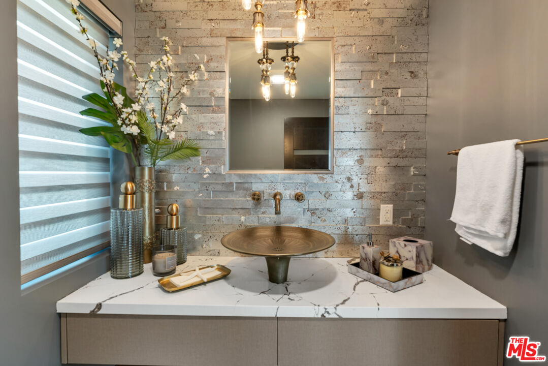 25423 Malibu Road Malibu, CA 90265 - Photo 17 of 71 a bathroom with a sink and a mirror