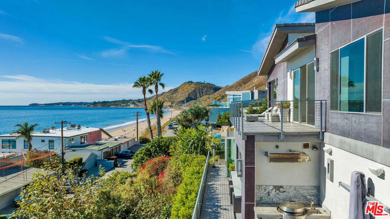 25423 Malibu Road Malibu, CA 90265 - Photo 49 of 71 a view of a house with a yard and potted plants