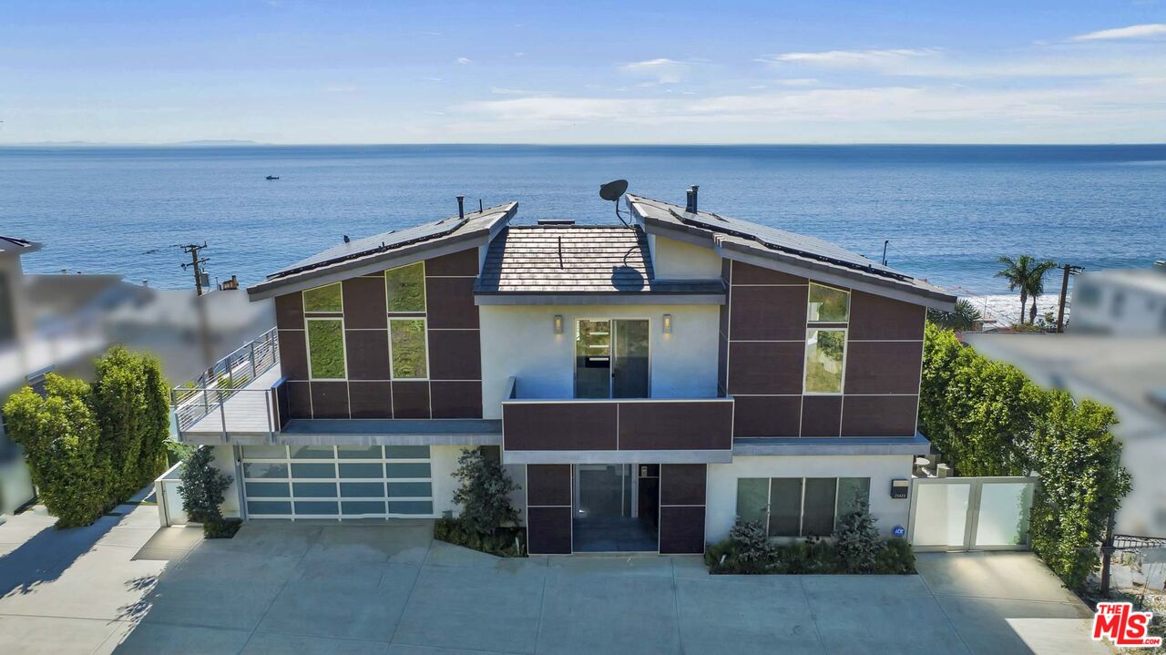 25423 Malibu Road Malibu, CA 90265 - Photo 5 of 71 a front view of a house with a garden