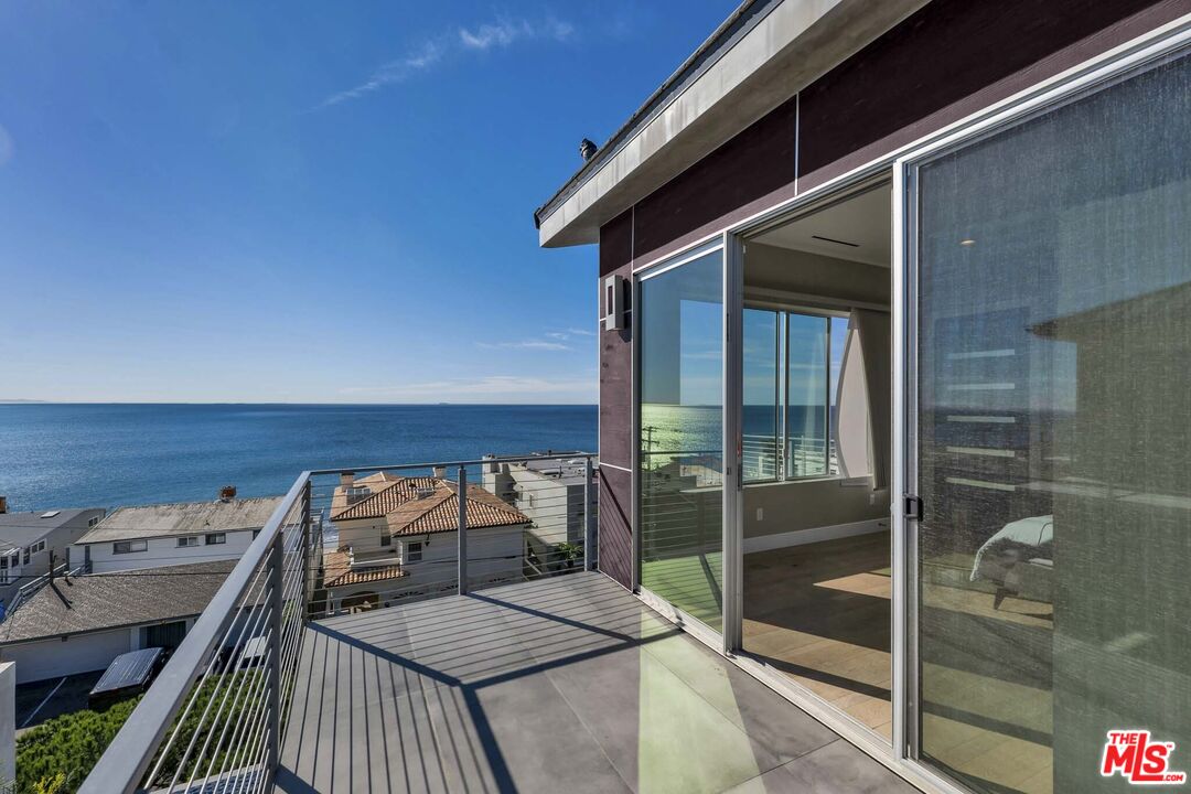 25423 Malibu Road Malibu, CA 90265 - Photo 55 of 71 a balcony with a table and chairs