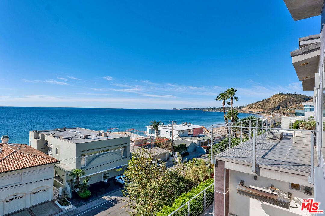 25423 Malibu Road Malibu, CA 90265 - Photo 58 of 71 a view of a patio with table and chairs