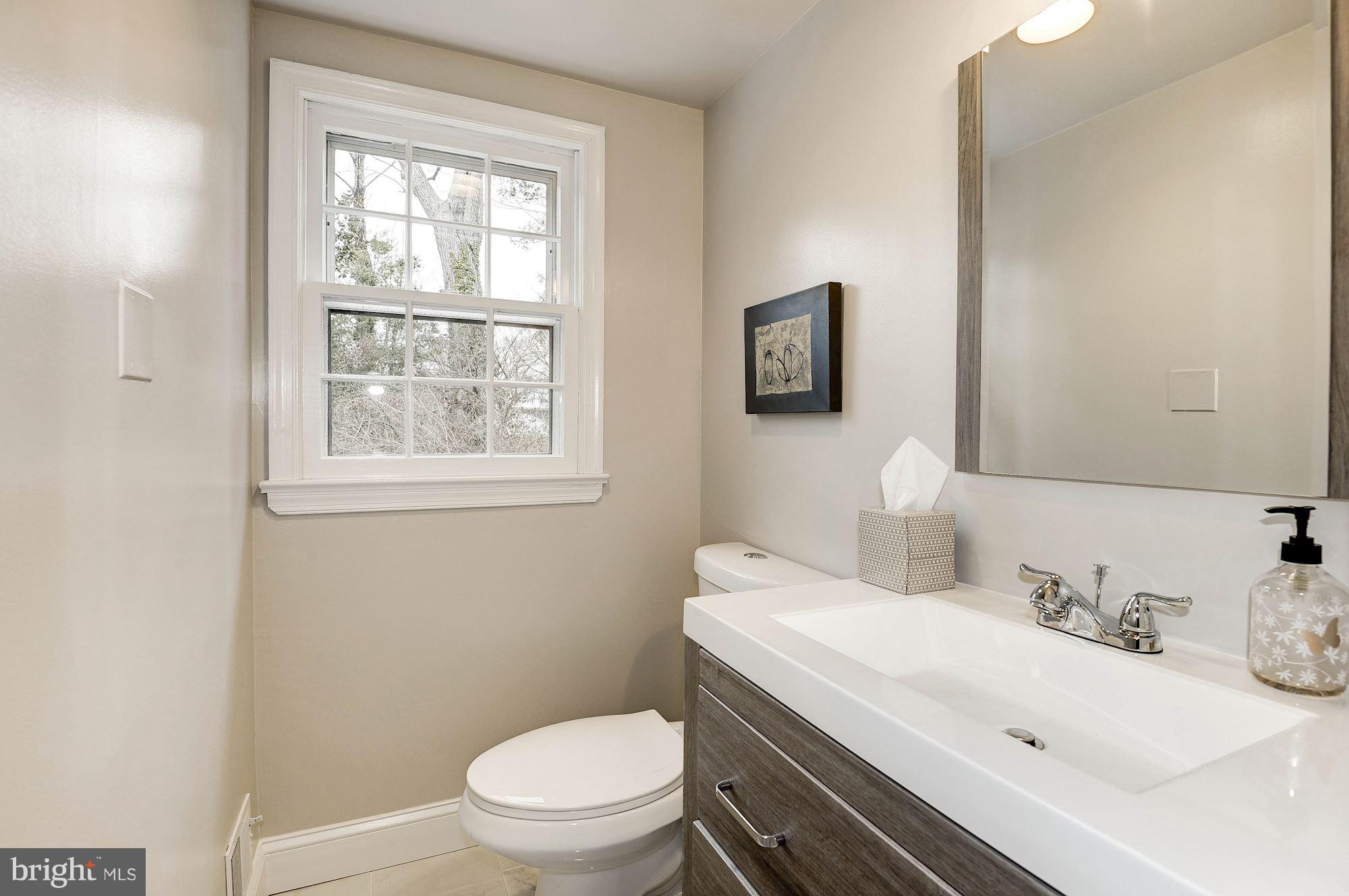 5000 Park Place Bethesda, MD 20816 - Photo 11 of 30 a bathroom with a toilet sink and mirror