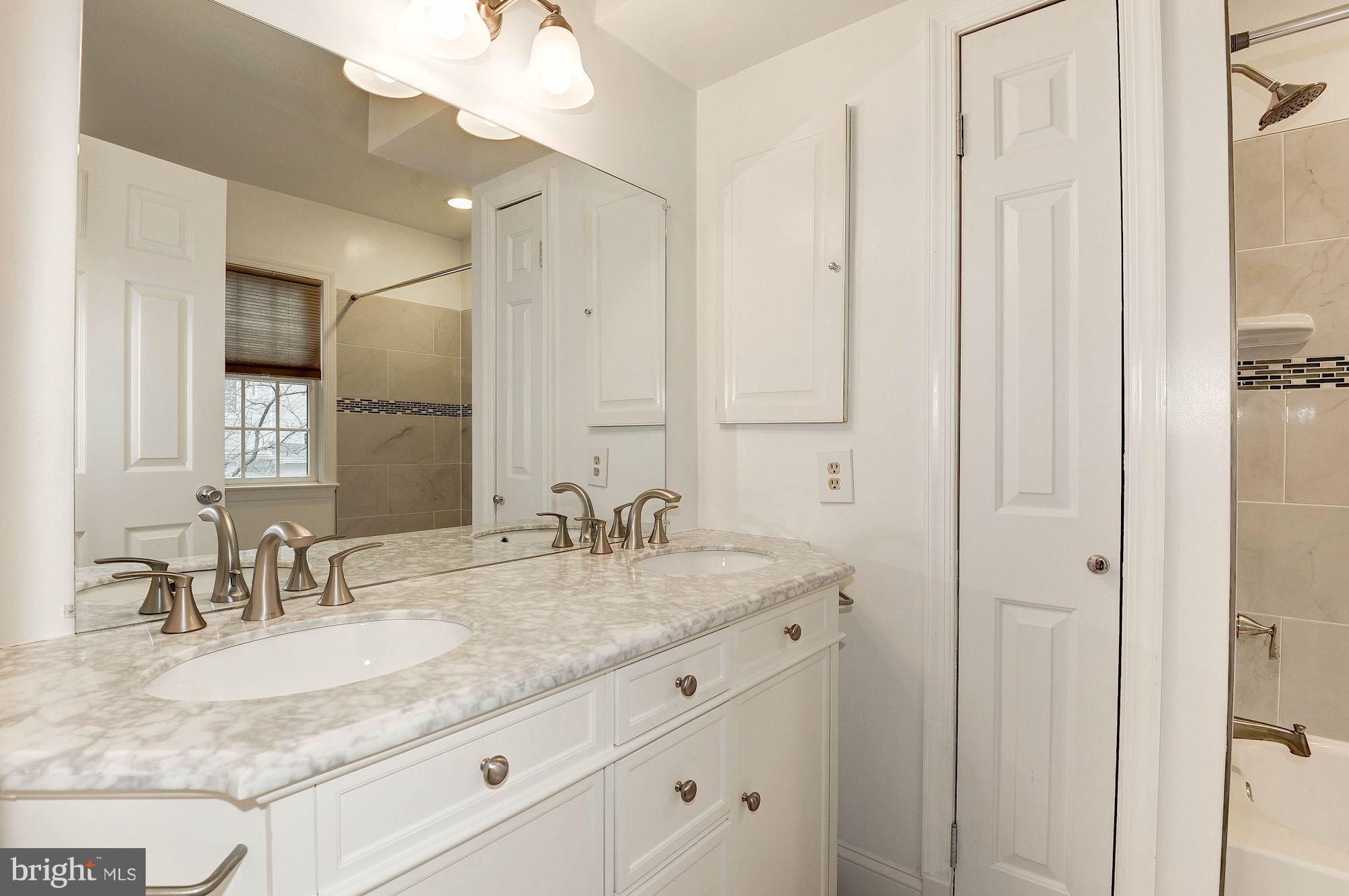 5000 Park Place Bethesda, MD 20816 - Photo 17 of 30 a bathroom with double sink and a mirror