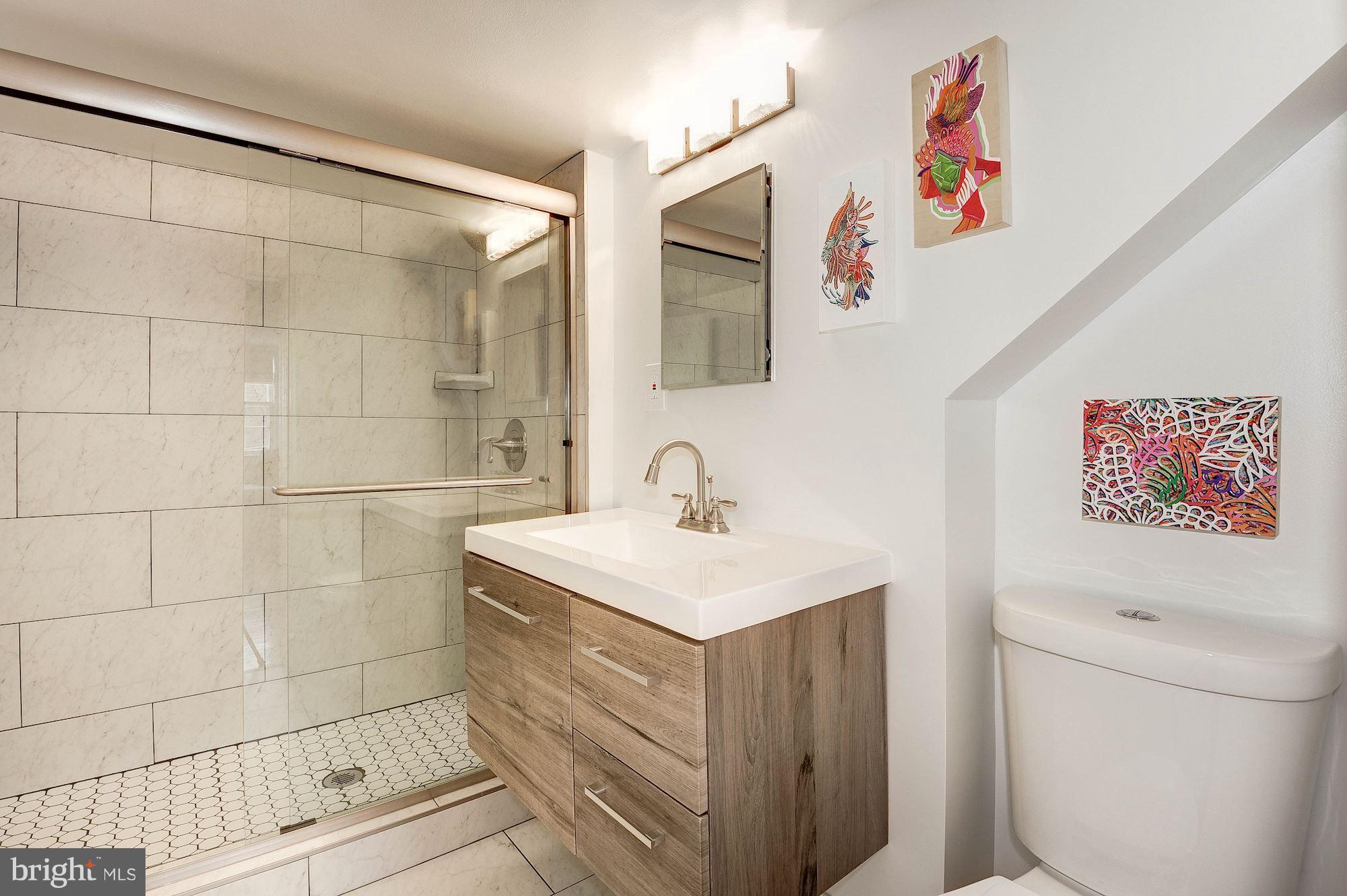 5000 Park Place Bethesda, MD 20816 - Photo 22 of 30 a bathroom with a sink mirror vanity and toilet