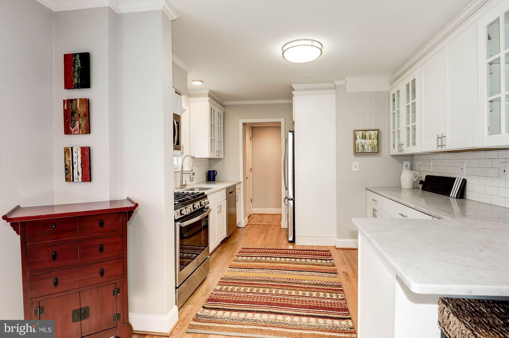 5000 Park Place Bethesda, MD 20816 - Photo 9 of 30 a kitchen with a refrigerator and a stove top oven