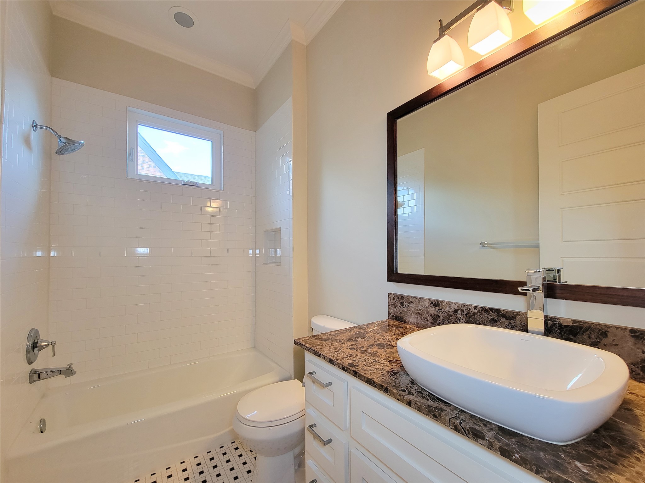 1140 West Cottage Street Houston, TX 77009 - Photo 23 of 37 a bathroom with a granite countertop sink a toilet a mirror and bathtub