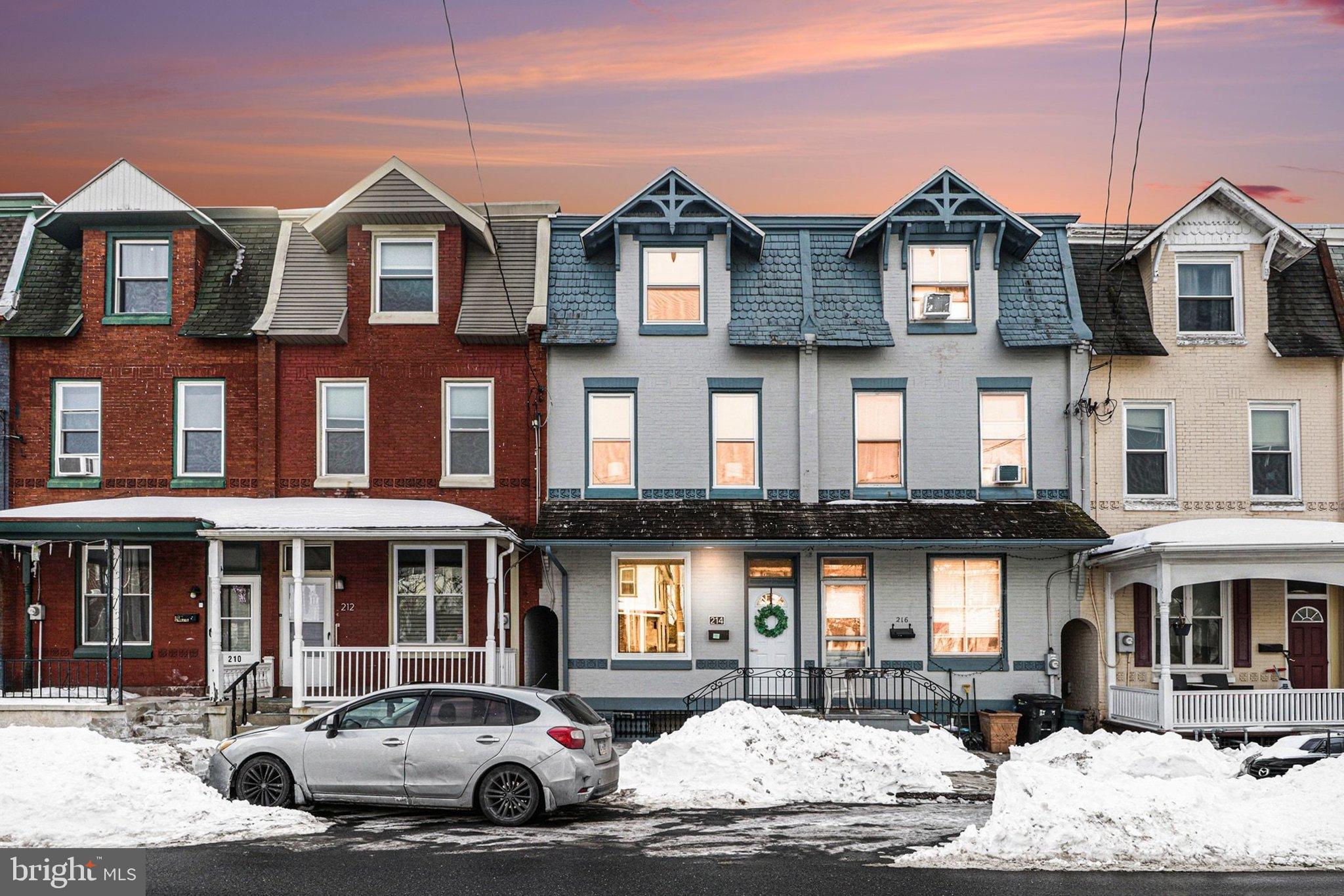 a front view of a residential apartment building with parking space