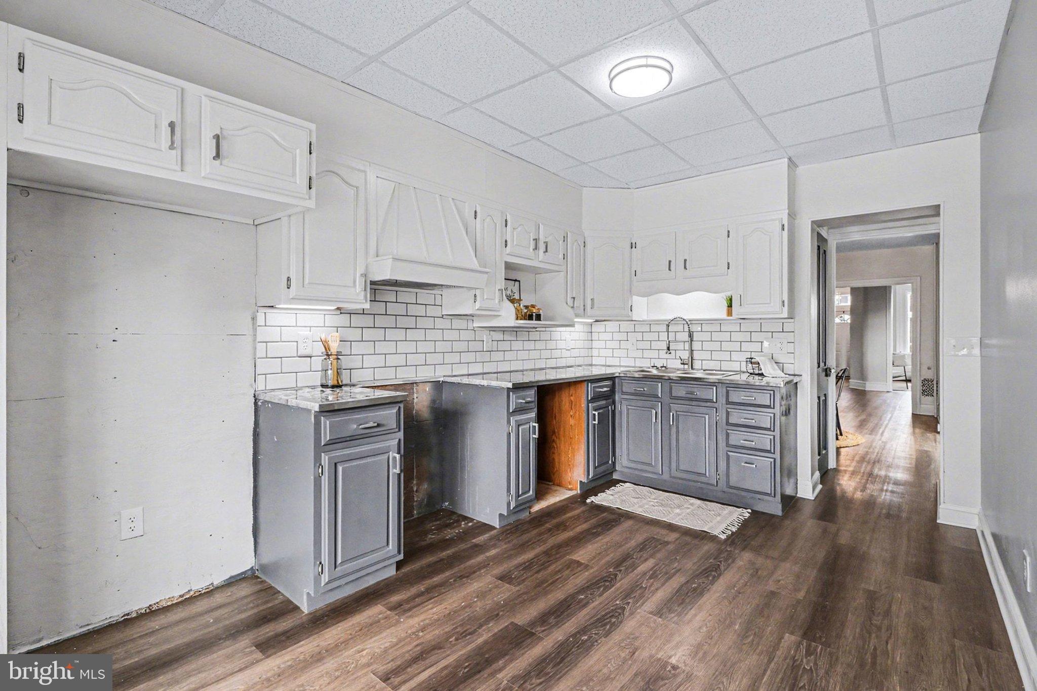 214 Chestnut Street Lebanon, PA 17042 - Photo 16 of 45 a kitchen with stainless steel appliances granite countertop a stove a sink dishwasher and a refrigerator with wooden floor