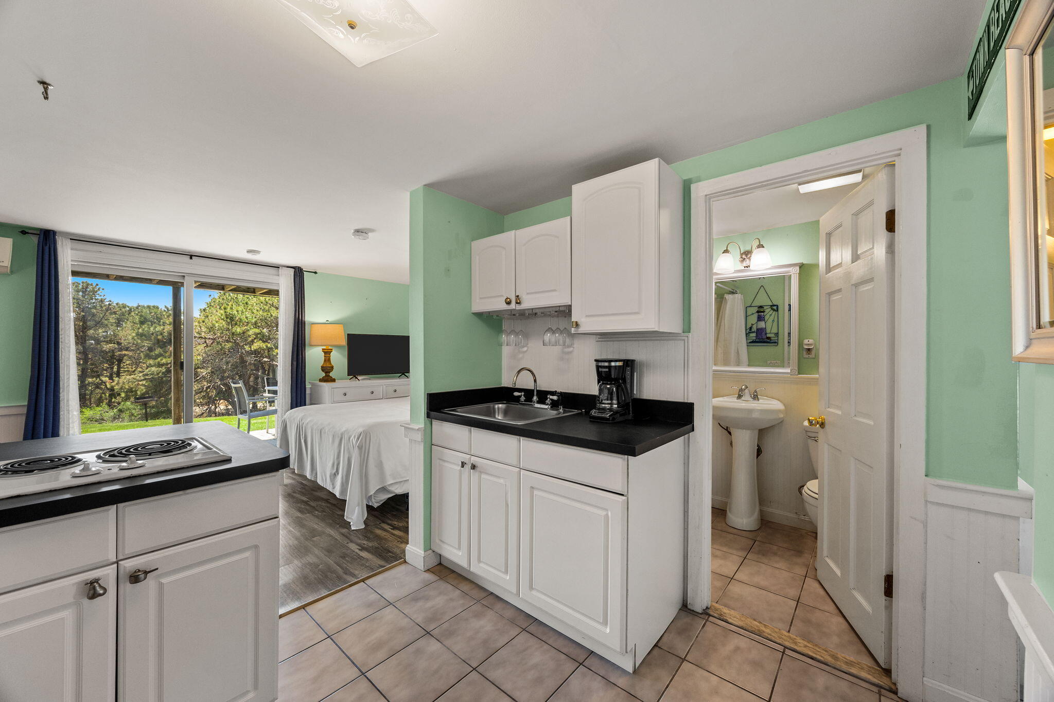 132 Shore Road, Unit 13 Truro, MA 02666 - Photo 8 of 21 a kitchen with a stove a sink and a cabinets