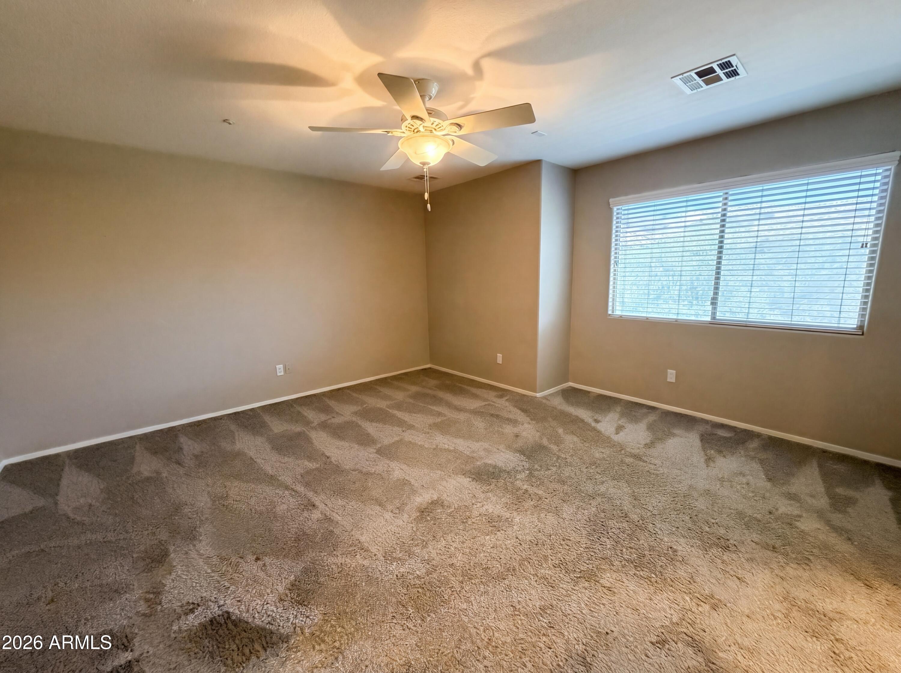1565 East Hopkins Road Gilbert, AZ 85295 - Photo 4 of 29 an empty room with windows and chandelier fan