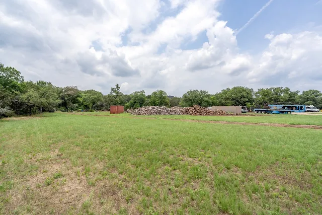 a view of a green field with wooden fence