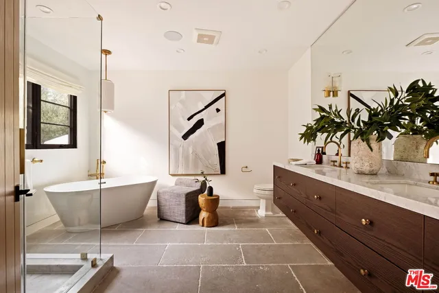 a bathroom with a tub sink and mirror