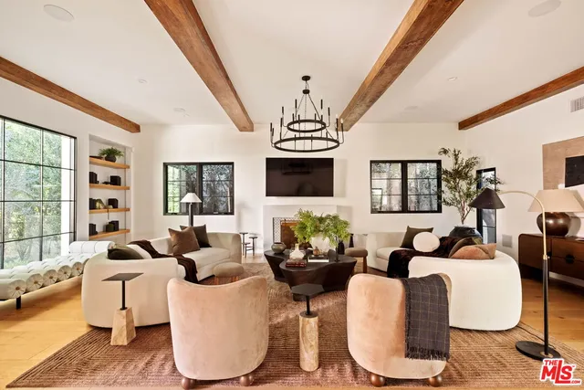 a living room with fireplace furniture and a large window