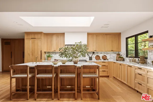 a kitchen with a sink and chairs