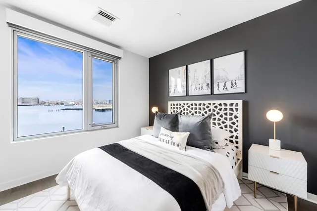 a bedroom with a large bed and a large window