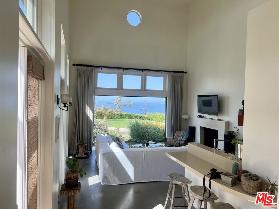29458 Bluewater Road, Unit GUESTHOUSE Malibu, CA 90265 - Photo 12 of 16 a view of a livingroom with furniture and a floor to ceiling window