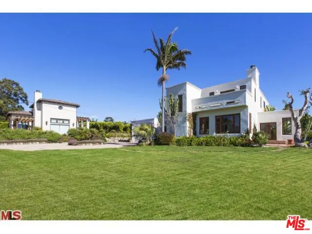 a front view of a house with a yard table and chairs