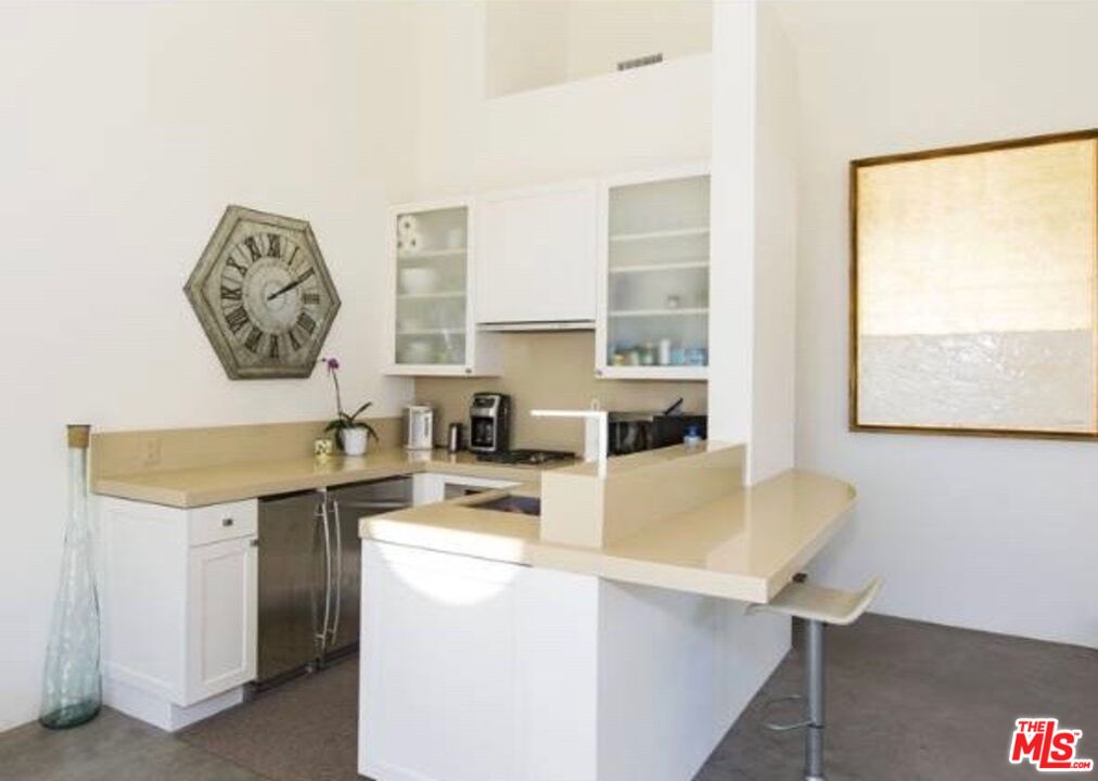 29458 Bluewater Road, Unit GUESTHOUSE Malibu, CA 90265 - Photo 5 of 16 a room with a window a sink and a dining table with chairs