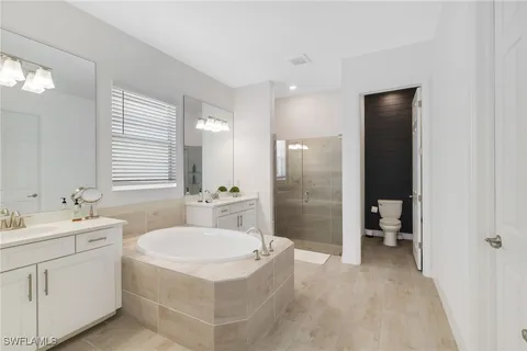 a bathroom with a sink toilet a mirror and shower