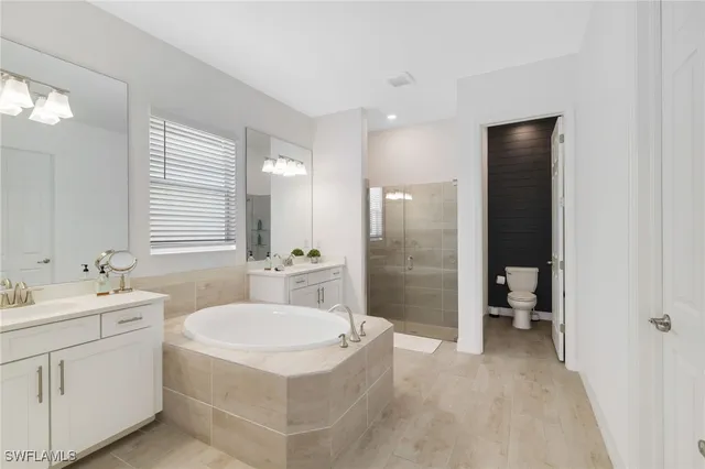 a bathroom with a sink toilet a mirror and shower