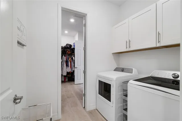 an aerial view of a house with swimming pool and outdoor seating