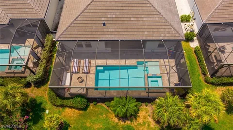 a aerial view of a house with swimming pool garden and lake view