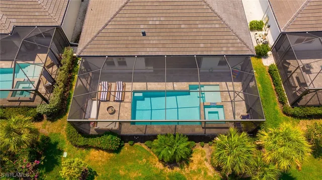 a aerial view of a house with swimming pool garden and lake view