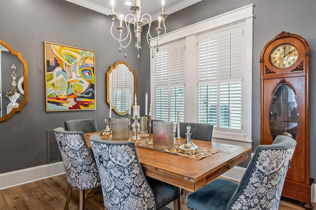 16241 Big Oak Bay Road Tyler, TX 75707 - Photo 5 of 40 Dining space featuring wood-finish flooring, a white chandelier, crown molding, and white plantation shutters on the windows