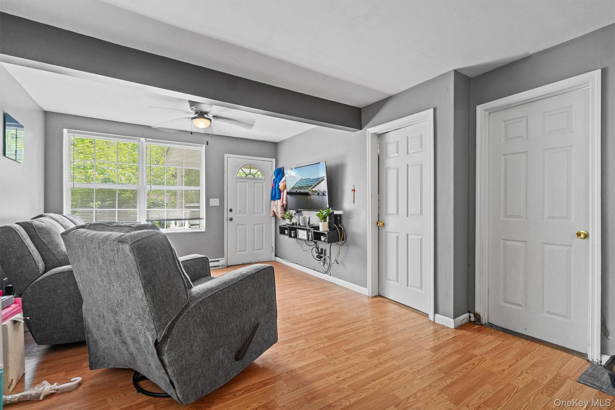 359 Lake Shore Drive Pine Bush, NY 12566 - Photo 8 of 25 Living room featuring light wood-style flooring, a ceiling fan, and baseboards