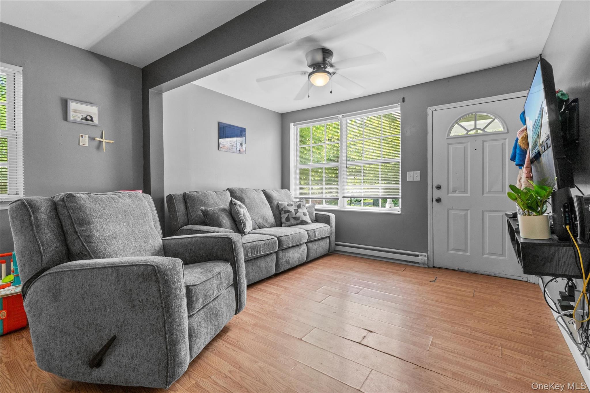 359 Lake Shore Drive Pine Bush, NY 12566 - Photo 9 of 25 Living room with baseboard heating, light wood finished floors, and ceiling fan
