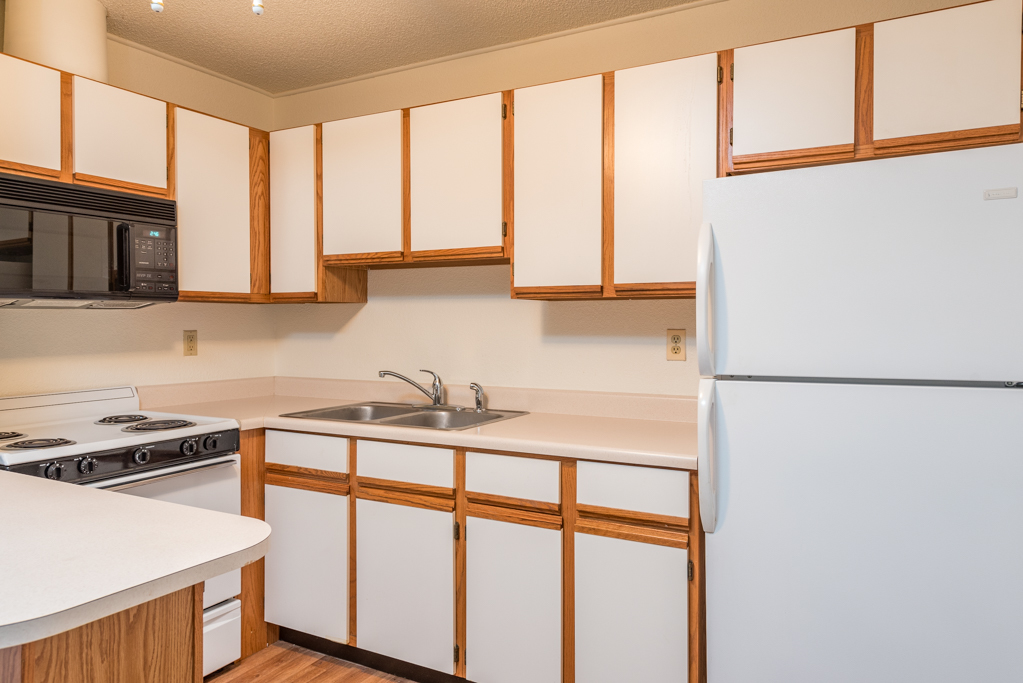 3305 Sunset Avenue, Unit 305 Waukegan, IL 60087 - Photo 9 of 23 a kitchen with stainless steel appliances a refrigerator sink and cabinets