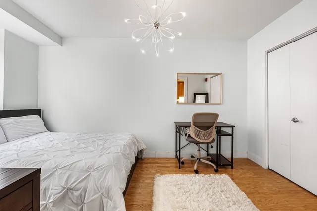 a bedroom with a bed and a desk