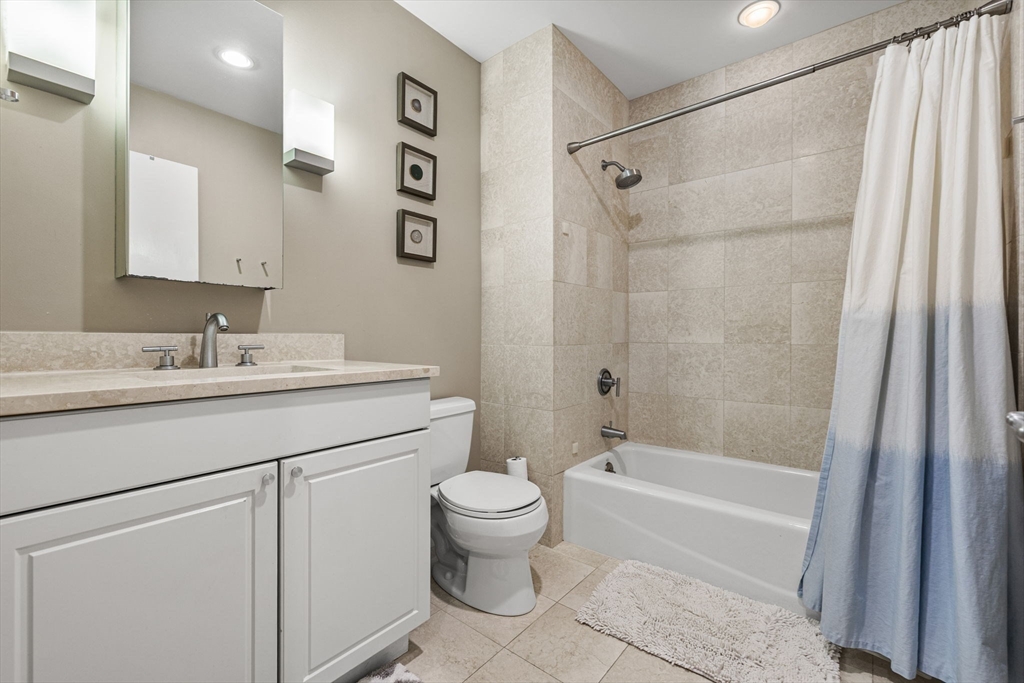 80 Broad Street, Unit 805 Boston, MA 02110 - Photo 16 of 22 a bathroom with a sink toilet and shower