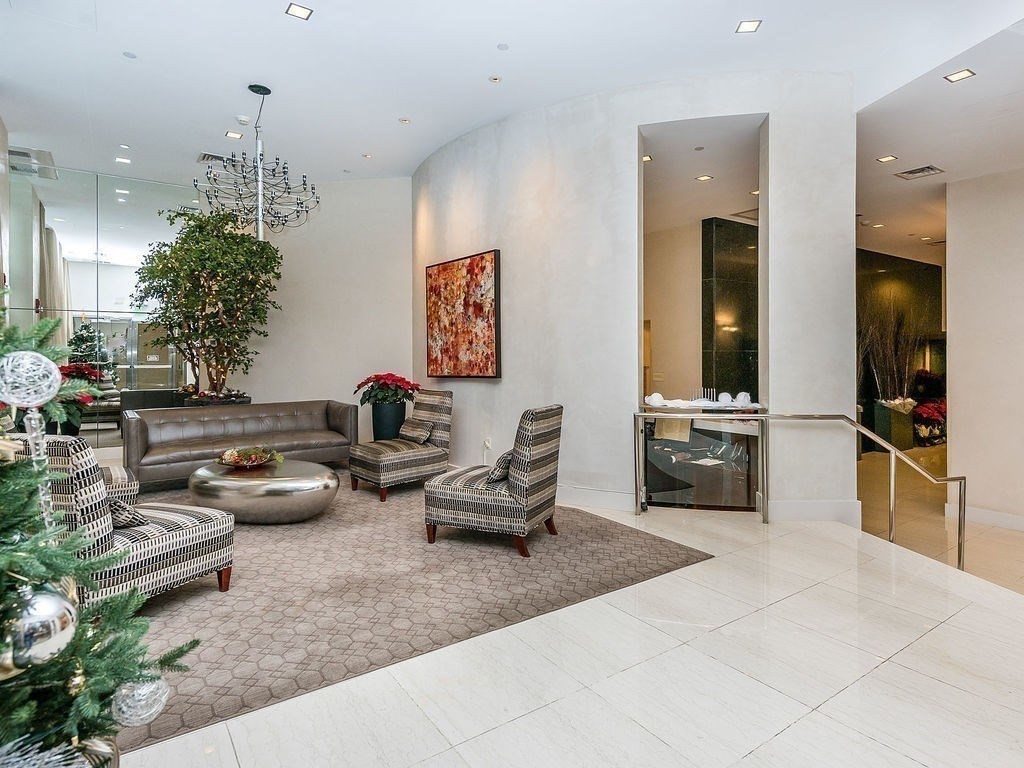 80 Broad Street, Unit 805 Boston, MA 02110 - Photo 18 of 22 a living room with furniture and a chandelier