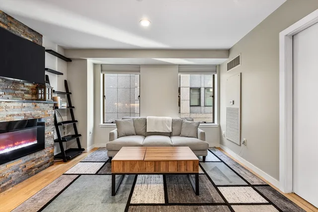 a living room with furniture a rug and a fireplace