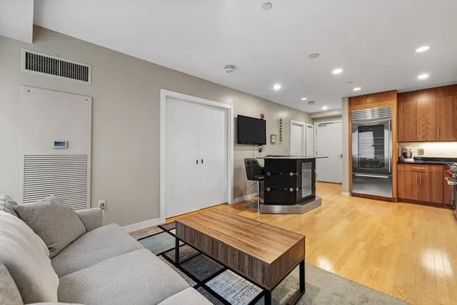 a room with furniture pool table and flat screen tv