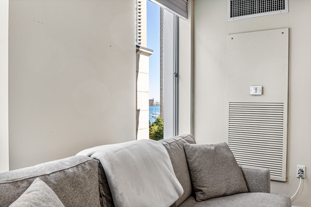 80 Broad Street, Unit 805 Boston, MA 02110 - Photo 8 of 22 a bedroom with a bed and a window